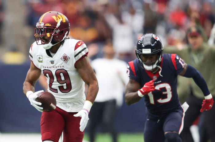 Washington Commanders cornerback Kendall Fuller (29) intercepts the ball against Houston Texans wide receiver Brandin Cooks (13) for a touchdown reception in the first quarter at NRG Stadium.
